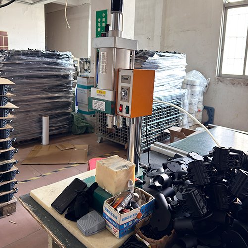 Pneumatic punch press creating ventilation holes in shower chair components