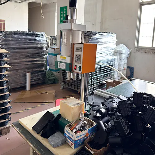 Pneumatic punch press creating ventilation holes in shower chair components