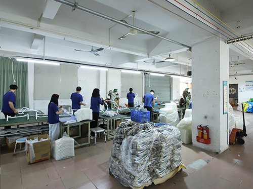 Staff performing assembly and quality checks on mobility equipment at Dinglian factory