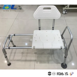A tub transfer bench securely placed inside a bathtub, with an elderly person demonstrating safe side-transfer onto the seat.